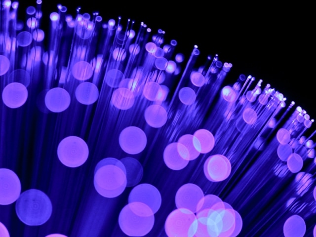 Abstract blueish purple dots on the end of fiber optic threads