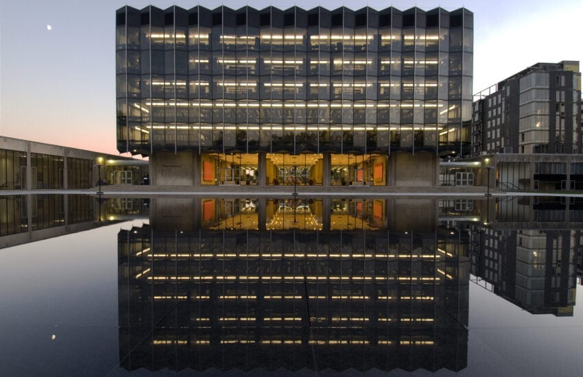 University of Chicago Law School, at night, with reflection in the Levin Reflecting Pool.