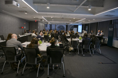 Large room with Life Sciences Scholars listening to panel presentation. 