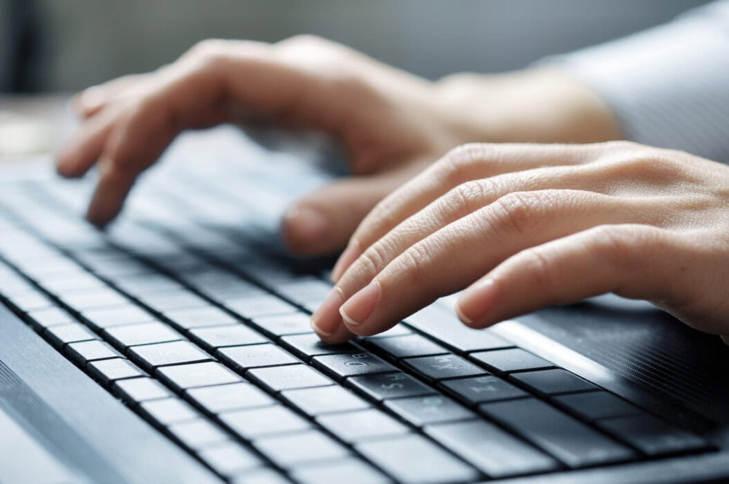 Close-up of typing female hands on keyboard