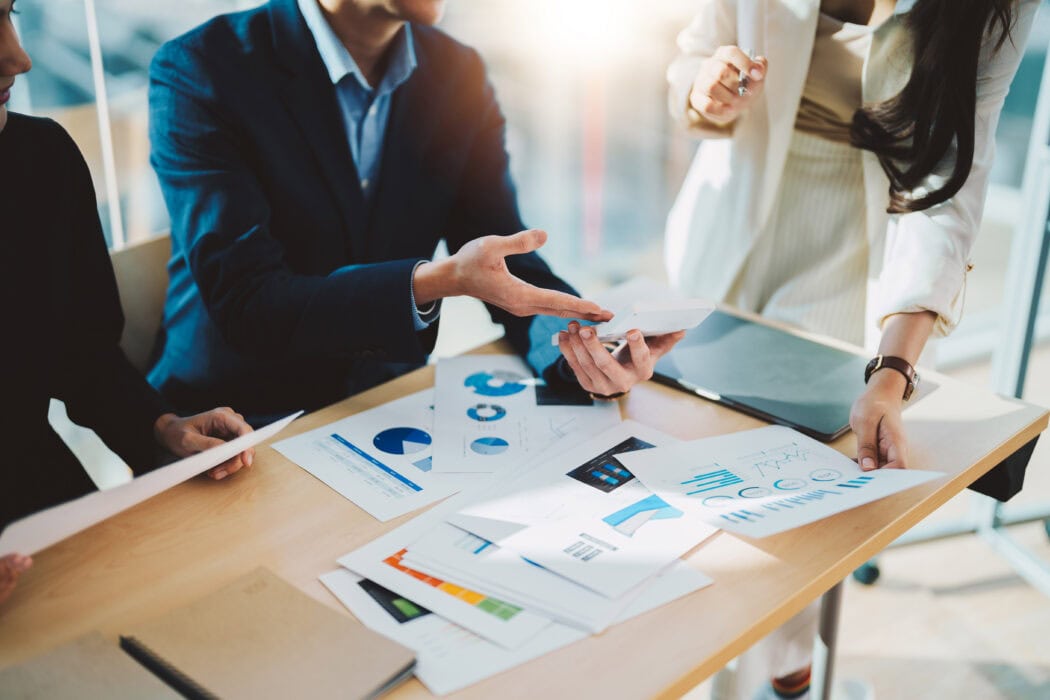 Stock image: business people discussing a PowerPoint Deck